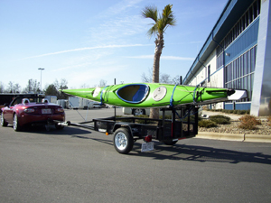 A car towing a kayak